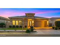 Charming single-story home with a manicured front yard, stone accents, and a two-car garage at 4462 S Frequency Dr, Mesa, AZ 85212