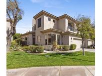 Contemporary two-story home with a well-manicured lawn and lush landscaping at 7282 E Del Acero Dr, Scottsdale, AZ 85258