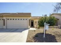 Charming single-story home with a well-manicured front yard, concrete driveway, and a two-car garage at 10960 E Monte Ave # 154, Mesa, AZ 85209