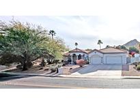 Charming single-story home with a three-car garage, red roof tiles, and manicured landscaping at 14236 N 28Th St, Phoenix, AZ 85032