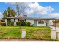 Charming single-story home features a well-maintained front yard with privacy landscaping and a covered front entry at 14608 N Montego Ct, Phoenix, AZ 85053