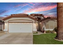 Inviting single-story home with a two-car garage, desert landscaping, and a tile roof at 15240 W Melissa Ln, Surprise, AZ 85374