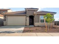 Charming single-story home with a well-manicured front yard, two car garage, and a beautiful tile roof at 17821 W Getty Dr, Goodyear, AZ 85338