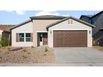 Charming single-story home featuring a two-car garage and neutral-toned stucco with low-maintenance desert landscaping at 2681 N Riverside Dr, Florence, AZ 85132