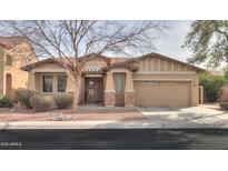 Charming single-story home featuring a two-car garage, desert landscaping, and a welcoming entryway at 325 W Seaside Dr, Casa Grande, AZ 85122