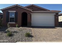 Beautiful single-story home with a two-car garage and a well-maintained, low-water landscaped front yard at 39980 W Anne Ln, Maricopa, AZ 85138