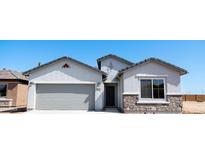 Charming single-story home featuring a two-car garage and stone accents at 4076 W Painted Horse Dr, Eloy, AZ 85131