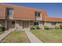 Charming townhome with a well-manicured front yard and a classic red tile roof at 5112 N 83Rd St, Scottsdale, AZ 85250