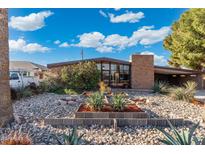 Charming brick home featuring desert landscaping with a covered carport at 945 W 10Th St, Mesa, AZ 85201