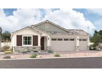 Charming single-story home featuring a three-car garage, stone accents, and a well-manicured desert landscape at 12369 W Marguerite Ave, Avondale, AZ 85323