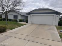 Charming single-story home with a two-car garage and a well-maintained front yard at 13034 W Peach Blossom Dr, Sun City West, AZ 85375