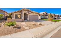 Charming single-story home with a xeriscaped front yard and neutral earth tone color palette at 1421 E Gary Dr, Chandler, AZ 85225