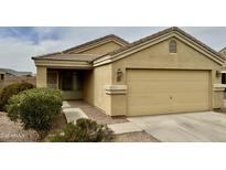 A charming single-Gathering home boasting a two-car garage and a well-maintained front yard with desert landscaping at 17914 N Fiano Dr, Maricopa, AZ 85138