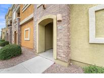 Condo entrance featuring an arched doorway and unit number, with neatly landscaped surroundings at 18250 N Cave Creek Rd # 105, Phoenix, AZ 85032