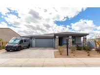 Charming single-story home featuring a spacious driveway, a two-car garage, and inviting stone accents at 2013 E Brooklyn Dr, Casa Grande, AZ 85122