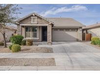 Charming single-story home with stone accents, a well-manicured lawn, and a two-car garage at 22644 E Quintero Ct, Queen Creek, AZ 85142