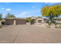 Charming single-story home with three-car garage and desert landscaping at 27582 N 67Th Way, Scottsdale, AZ 85266