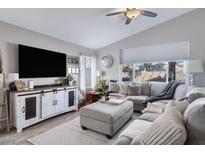 Inviting living room featuring a comfortable sectional sofa and stylish media console at 4558 W Joshua Blvd, Chandler, AZ 85226