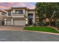 Stunning two-story home with a three car garage, lush landscaping, and a beautiful arched entry way at 6508 N 28Th St, Phoenix, AZ 85016