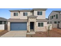 Charming two-story home featuring a blue garage door, stone accents, and a well-maintained front yard at 7400 W Quail Track Dr, Peoria, AZ 85383