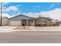 Charming single-story home featuring a brick facade, well-maintained landscaping, and a two-car garage at 76 N 133Rd St, Chandler, AZ 85225