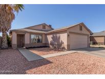 Charming single-story home with desert landscaping, covered porch, and attached two car garage at 11529 W Columbine Dr, El Mirage, AZ 85335