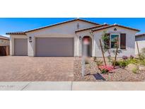 Charming single-story home featuring a three-car garage, desert landscaping, and a neutral color palette at 12374 W Marguerite Ave, Avondale, AZ 85323