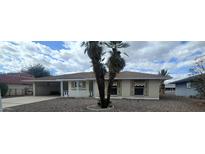 Charming single-story home featuring desert landscaping and a covered parking area at 13816 N 103Rd Ave, Sun City, AZ 85351