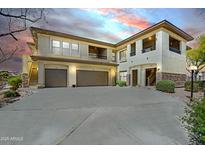 Two-story beige stucco home featuring dual garages and private balconies, set against a colorful twilight sky at 16800 E El Lago Blvd # 2072, Fountain Hills, AZ 85268