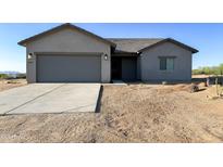 Charming single-story home featuring a two-car garage and low-maintenance desert landscaping at 16917 E Dixileta Dr, Rio Verde, AZ 85263