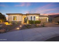 Charming home showcasing desert landscaping, a stone walkway, and a two-car garage at 19051 N 259Th Ave, Buckeye, AZ 85396