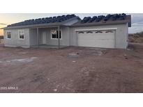 Newly constructed single-story home featuring a two-car garage and desert landscaping at 24184 E King Rd, Florence, AZ 85132