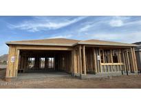 Unfinished home exterior framing, showcasing a modern design with a spacious two-car garage under construction at 25369 N 75Th Ln, Peoria, AZ 85383