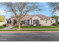 Charming single-story home with a well-manicured lawn and stone accents, creating an inviting curb appeal at 2838 E Vaughn Ct, Gilbert, AZ 85234