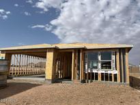 A new home under construction with wood framing and a blue sky in the background at 7688 W Saddlehorn Rd, Peoria, AZ 85383