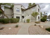 Inviting two-story condo featuring desert landscaping and private entryways, creating a welcoming first impression at 9455 E Raintree Dr # 2032, Scottsdale, AZ 85260