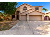 Two-story home featuring a two-car garage, neutral colors, and desert landscaping at 10452 E Florian Ave, Mesa, AZ 85208