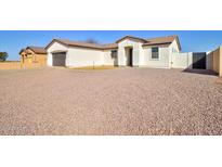 Charming single-story home features a neutral color palette and a well-maintained desert landscape at 12722 W Diaz Dr, Arizona City, AZ 85123