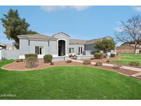 Charming single-story home with a well-manicured lawn, desert landscaping and a tiled roof at 2102 E Norwood St, Mesa, AZ 85213