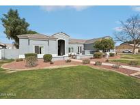 Charming single-story home with manicured lawn and low maintenance desert landscaping in the front yard at 2102 E Norwood St, Mesa, AZ 85213