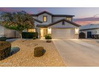 Charming two-story home showcasing a well-manicured front yard, desert landscaping, and an attached two-car garage at 2708 E Desert Rose Trl, San Tan Valley, AZ 85143