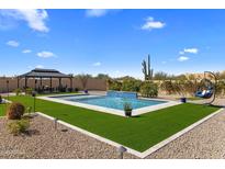 Backyard features a gorgeous pool with waterfall feature, desert landscaping, cabana and hanging swing at 30416 N 64Th Street --, Cave Creek, AZ 85331