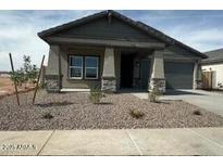 Charming single-story home with neutral stucco, rock landscaping, and attached two-car garage at 36972 W Santa Maria St, Maricopa, AZ 85138