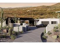 Stunning modern home featuring desert landscaping, sleek architectural design, and a private driveway with a luxury car at 42400 N Sierra Vista 2 Dr, Cave Creek, AZ 85331