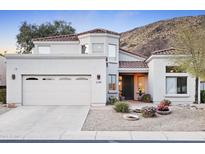 Charming two-story home with a desert landscape, mountain views, and a spacious two car garage at 6348 W Hill Ln, Glendale, AZ 85310