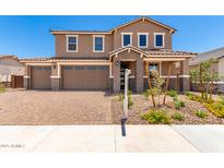 Charming two-story home with a brick driveway, three-car garage, and beautiful landscaping at 12373 W Marguerite Ave, Avondale, AZ 85323