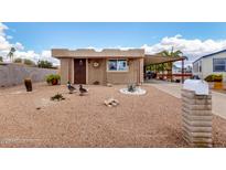 Charming single-story home featuring a quaint front yard, mature cactus, and covered parking at 1779 S 74Th St, Mesa, AZ 85209