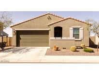 Charming single-story home featuring a two-car garage and well-maintained landscaping at 37236 N Navarra Rd, San Tan Valley, AZ 85140