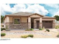 Charming single-story home showcasing a stone veneer, neutral palette, two-car garage and low-maintenance desert landscaping at 40563 W Michaels Dr, Maricopa, AZ 85138