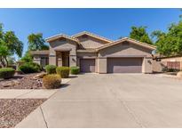 Spacious single-story home with desert landscaping and a large three-car garage at 4192 E Carriage Way, Gilbert, AZ 85297